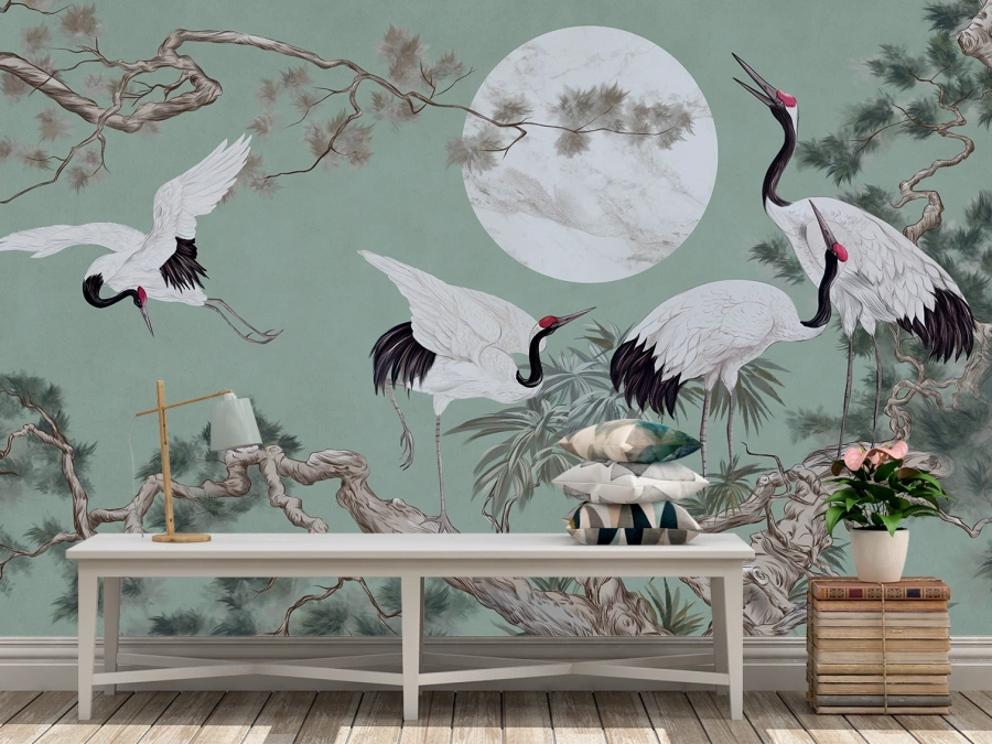 Tapet artistic cu cocori sub lună plină pe fundal verde închis.